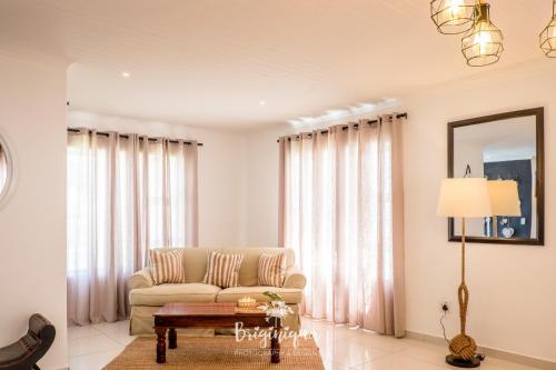 a living room with a couch and a table at SHB Sonvanger in St Helena Bay