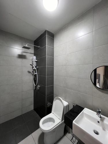 a bathroom with a toilet and a sink and a mirror at Urban Suites - George Town, Penang in Jelutong