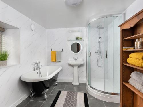 a white bathroom with a sink and a shower at 2 bed property in Mawbray Cumbria SZ214 in Mawbray