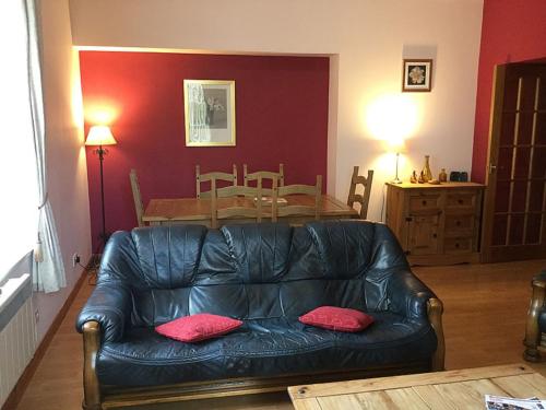 a living room with a leather couch and a table at Apartment Old Edinburgh Cottage by Interhome in Inverness