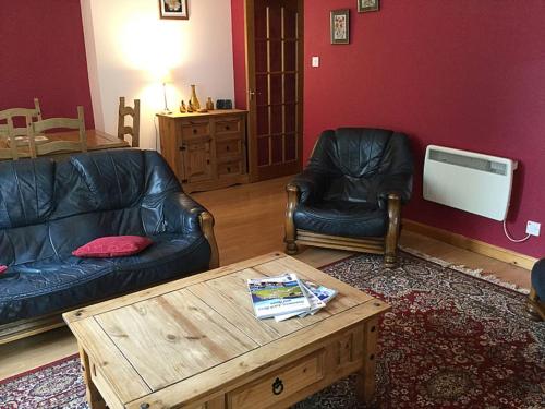 a living room with a couch and a coffee table at Apartment Old Edinburgh Cottage by Interhome in Inverness