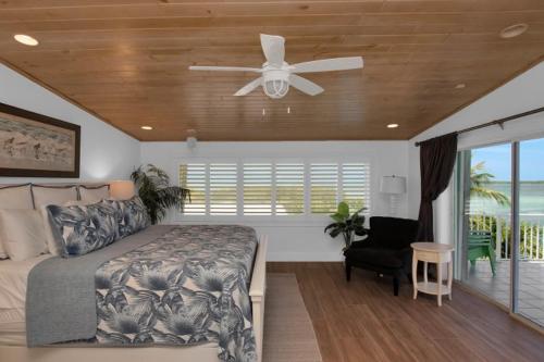 a bedroom with a bed and a ceiling fan at Conch Bar South in Tavernier