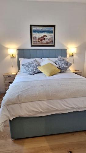 a bedroom with a large bed with pillows on it at Rural Cornish Cottage in Truro