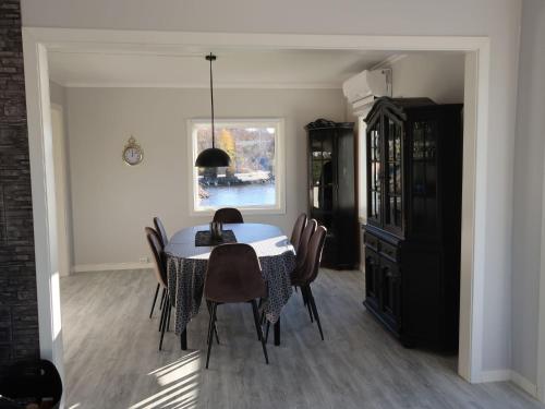 a dining room with a table and chairs at Holiday Home Sjøtun - FJS155 by Interhome in Hyllestad