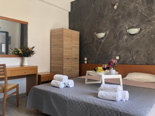 a bedroom with a bed with towels on it at Central Guest House Skiathos in Skiathos Town