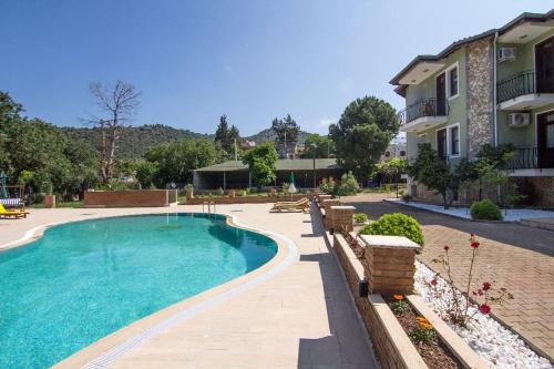 a large swimming pool in front of a house at Kayakoy Houses by LookBookHoliday in Kayakoy