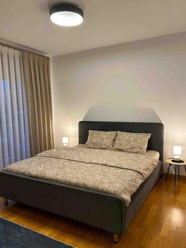 a bedroom with a large bed with two pillows at Luxurious House for Rent in Pristina