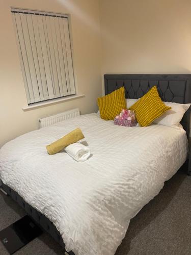 a bed with two towels on top of it at GM247 Nice Accommodation Stays in Wigan