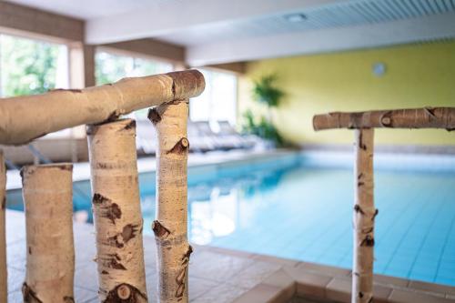 a close up of a fence in front of a swimming pool at Hotel Birkenmoor in Scheidegg