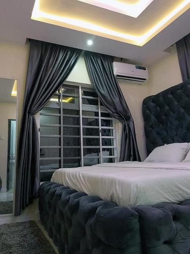 a bedroom with a large bed and a window at JKA 1-BEDROOM-Apart 24HRS POWER Unlimited WIFI , GARDEN PATIO AREA ,FREE DAILY HOUSEKEEPING in Lagos