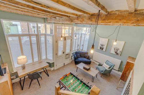 a living room with a pool table in the middle at Marsh Mallow Cottage - Hot Tub Packages Available in Loughborough