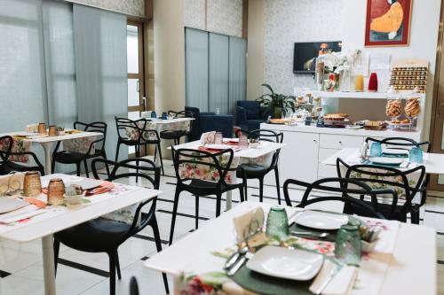 a dining room with white tables and chairs at B&B Barone Liberty & Luxury SPA in Gallipoli