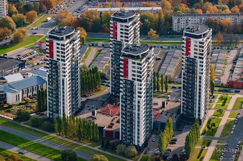an overhead view of three tall buildings in a parking lot at Skanstes Virsotnes Flying Bed Apartment (Skanstes Heights) in Riga