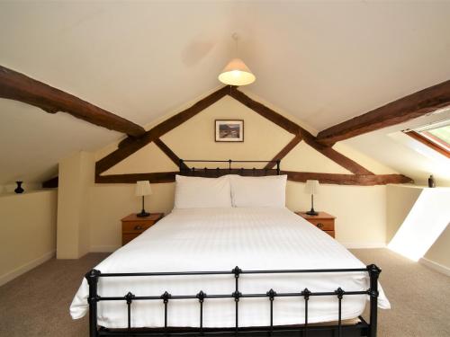 a bedroom with a large white bed in a attic at 1 Bed in Rhayader 45386 in Llangurig