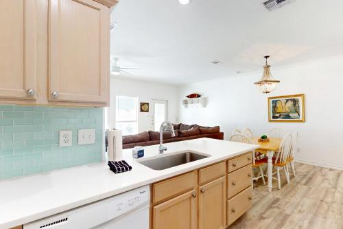 a kitchen with a sink and a table at Beach Haven Unit 201 in Corpus Christi