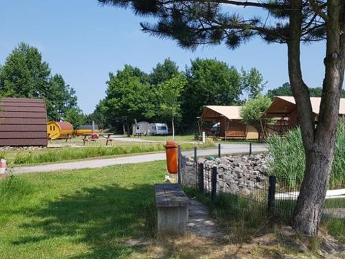 an orange fire hydrant sitting next to a tree at Camping Heidekamp in Versmold