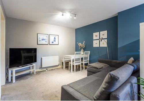a living room with a couch and a table at The Studio @ No. 6 in Brimscombe