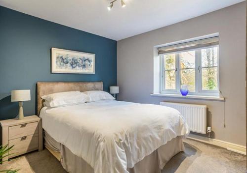 a bedroom with a large bed and a window at The Studio @ No. 6 in Brimscombe