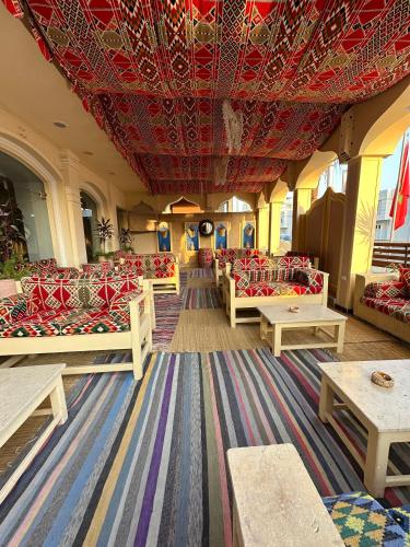a room with couches and tables and a red ceiling at Elaria Hotel Hurgada in Hurghada
