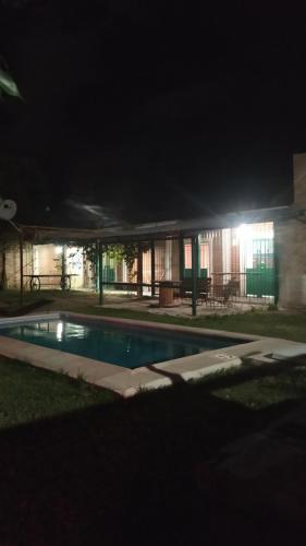 a house with a swimming pool at night at Cabañas en Koslay Ñalala Ivoqué con piscina climatizada en épocas cálidas in Juana Koslay 