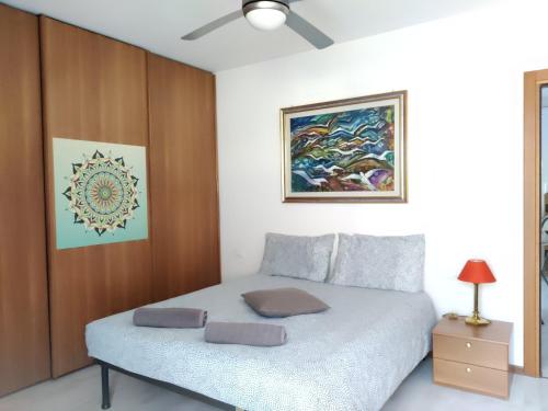 a bedroom with a bed and a painting on the wall at Casa Akira in Riva del Garda