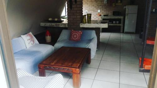 a living room with two couches and a coffee table at Tsumeb Backpackers & Safari in Tsumeb