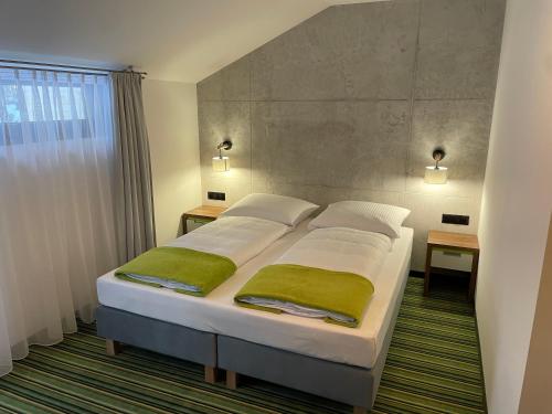 1 dormitorio con 1 cama con toallas verdes en Kompleks Taaka Ryba en Sumina