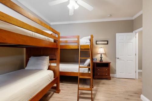 two bunk beds in a small room with a lamp at Villages of Crystal Beach: Serenity in Destin
