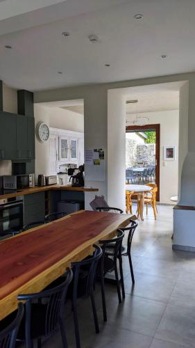 a kitchen with a large wooden table and chairs at L'ARONDE in Olloy-sur-Viroin
