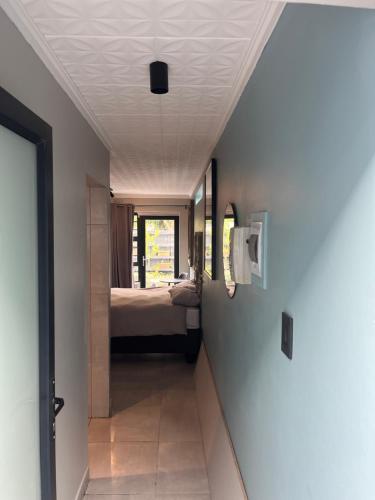 a hallway leading to a bedroom with a bed at 28 on Symonds luxstudio 6 in George