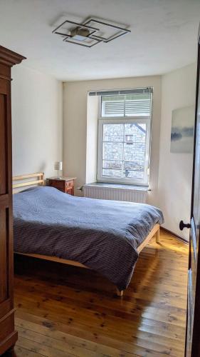a bedroom with a bed and a window at L'ARONDE in Olloy-sur-Viroin