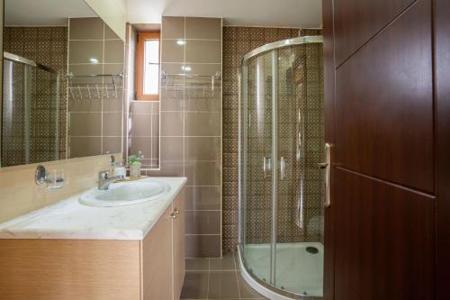 y baño con lavabo y ducha. en Myrto Villa with sea view, en Lefkogeia