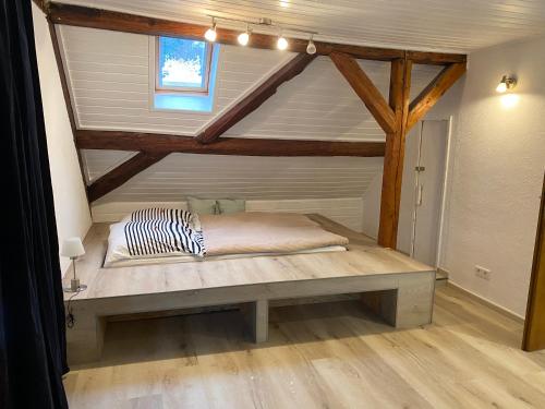 a bed in a room with a wooden ceiling at Großherzögliches Jägerhaus in Bensheim