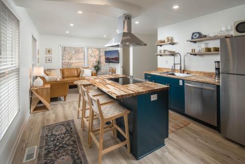 a kitchen with blue cabinets and a counter top at Sunflower Suite at The Wanderer in Boone