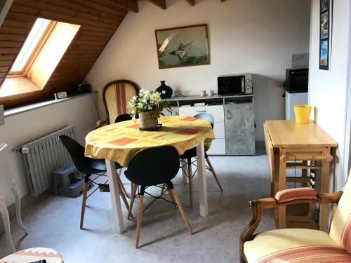 une cuisine et une salle à manger avec une table et des chaises dans l'établissement Appartement lumineux avec vue sur la mer à Port-Bail 70 m² 4 pers., à Portbail