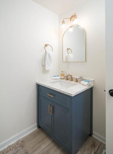 a bathroom with a blue sink and a mirror at Sunflower Suite at The Wanderer in Boone