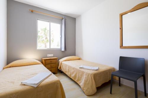 Postel nebo postele na pokoji v ubytování Apartamentos Zodiac