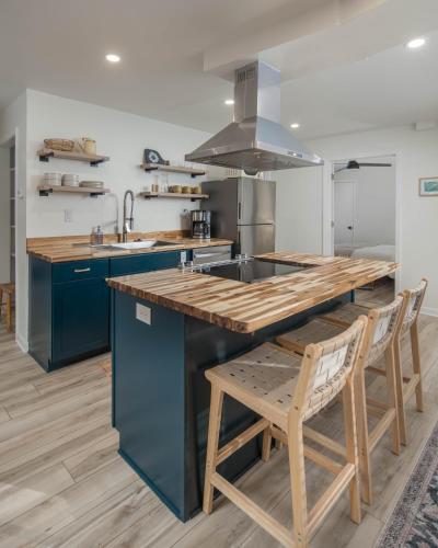 a kitchen with blue cabinets and a wooden counter top at Sunflower Suite at The Wanderer in Boone