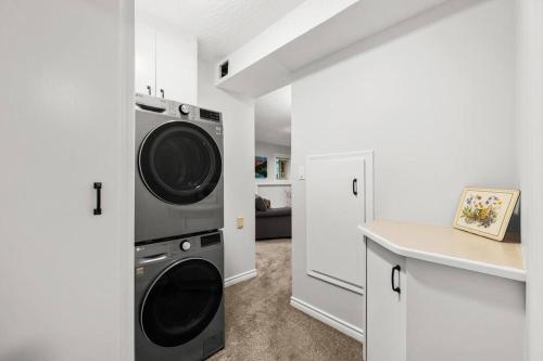 a laundry room with a washer and dryer at Mountain Retreat in North Saanich