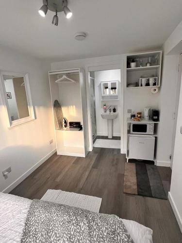 a bedroom with a bed and a sink in it at En-suite Room with Independent Entrance. in Edinburgh