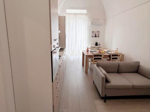 a living room and kitchen with a couch and a table at Donna Anna in Polignano a Mare