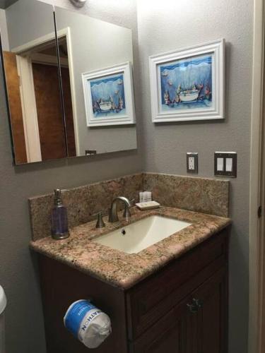 a bathroom with a sink and a mirror at Harbor House in Morro Bay in Morro Bay