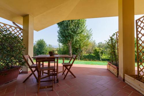a patio with a wooden table and chairs on a patio at I 7 MELI in Sarzana