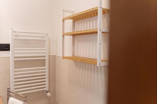 a bathroom with white shelves in a room at I 7 MELI in Sarzana