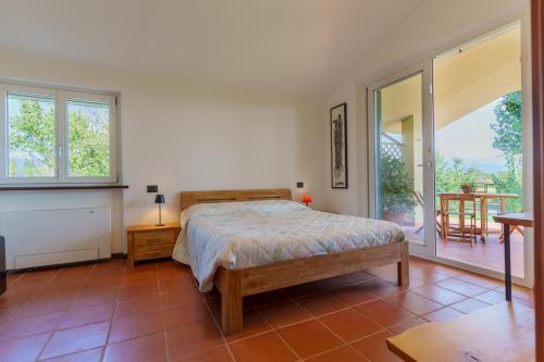 a bedroom with a bed and a table and windows at I 7 MELI in Sarzana