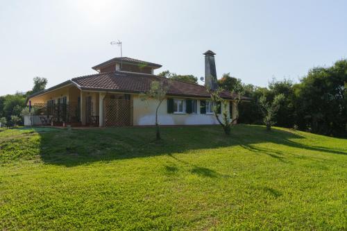 a small house with a grassy yard in front of it at I 7 MELI in Sarzana