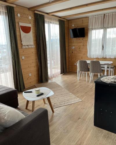 a living room with a couch and a table at Seoski turizam Domaćinstvo Tošanić in Žigale