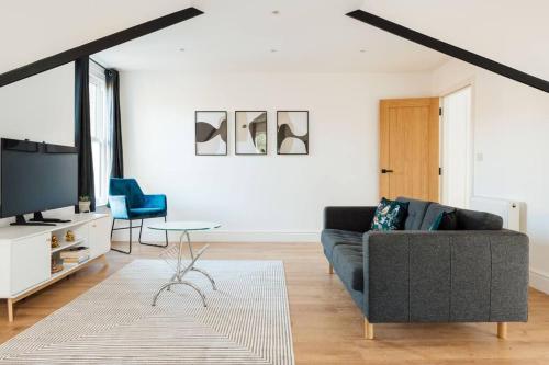 a living room with a couch and a tv at Spacious & Modern Two Bedroom Apartment in Catford, London in Catford