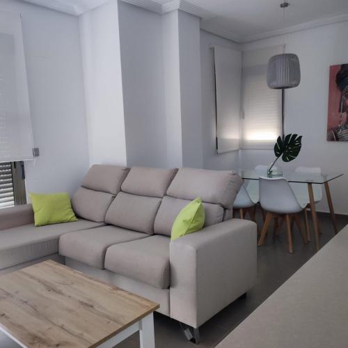 a living room with a couch and a table at Modern and Stylish Apartament sea ​​views in Guardamar del Segura