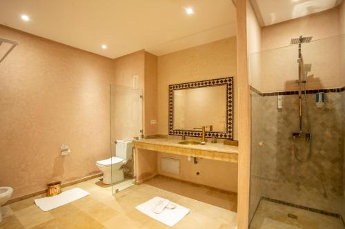 a bathroom with a toilet and a sink and a shower at Riad Kenza in Marrakech